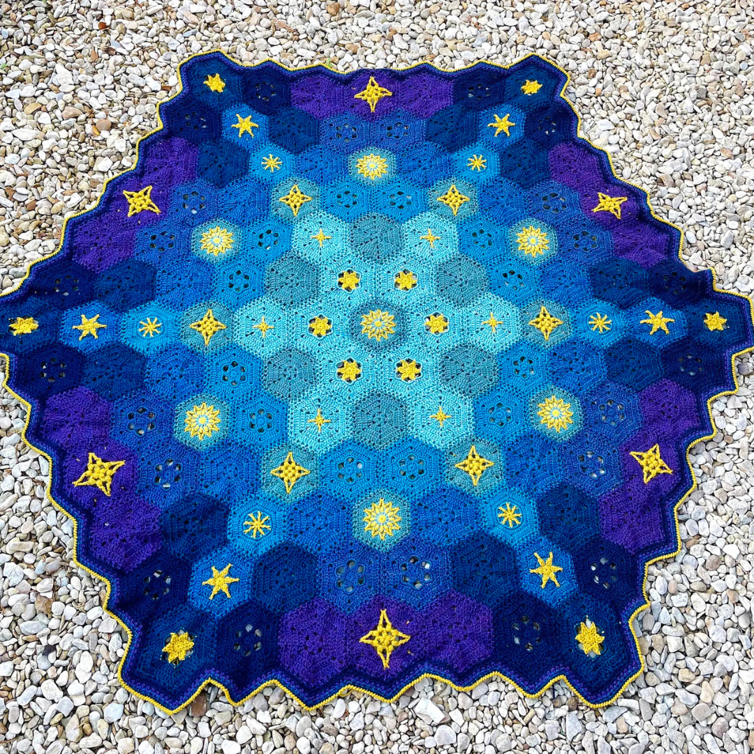 crocheted starlite blanket on the ground
