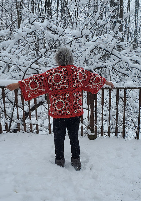 Person wearing a red Turkish granny square crochet top standing in a snowy forest.
