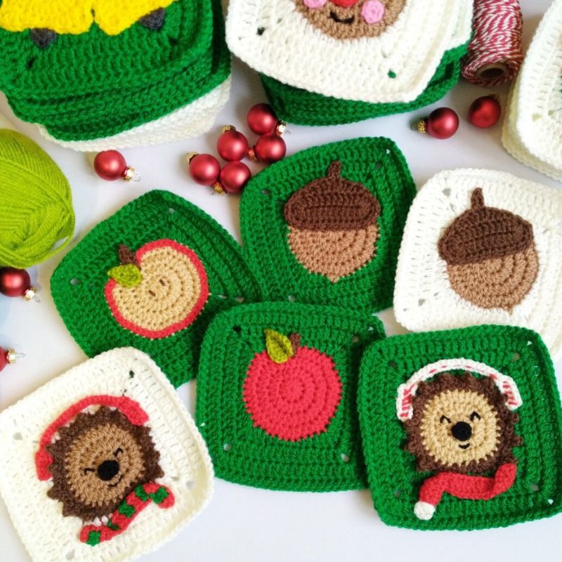 Collection of crocheted christmas granny squares with various designs on a white background