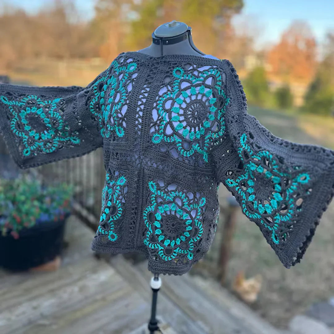 Black and teal Crocheted Turkish granny square top on a mannequin with a blurred outdoor background